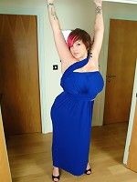 Busty Dors squeezes tits into tight blue dress and plays with pussy